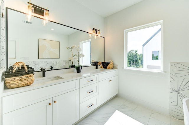 4043 Buck St, Houston, TX 77020 - bathroom with double vanity, marble look tile flooring, baseboards, and recessed lighting