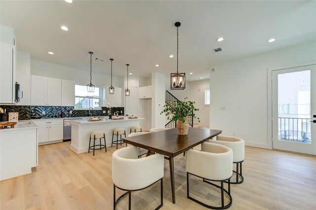 4041 Buck St, Houston, TX 77020 - dining room with light wood-type flooring, recessed lighting, a chandelier, and stairway