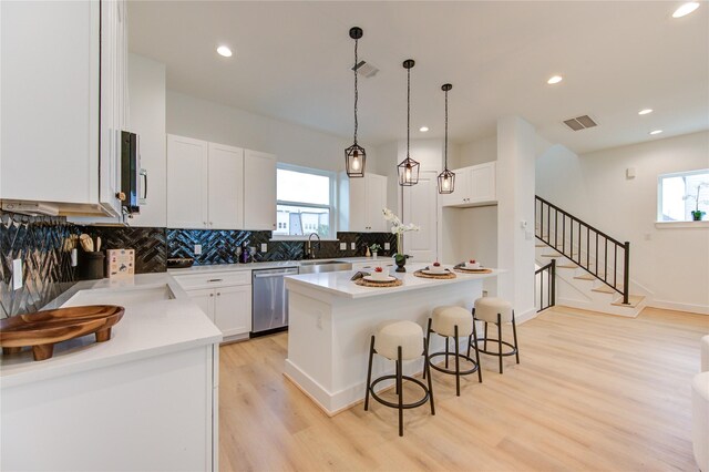 4041 Buck St, Houston, TX 77020 - kitchen with stainless steel appliances, a breakfast bar area, plenty of natural light, decorative backsplash, and recessed lighting