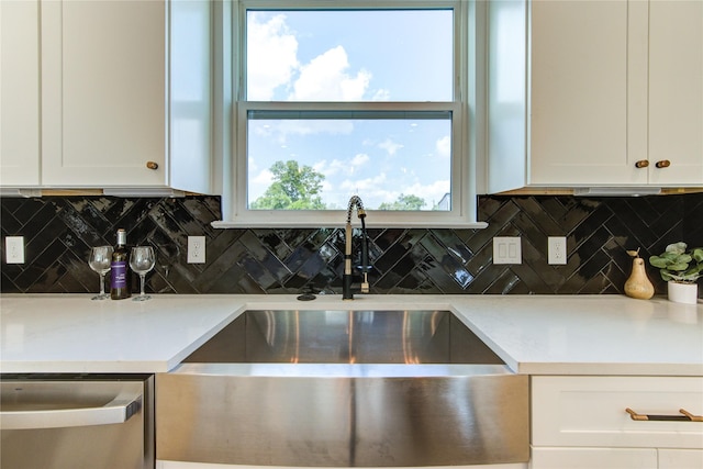 4041 Buck St, Houston, TX 77020 - kitchen with a sink, stainless steel dishwasher, white cabinets, and tasteful backsplash