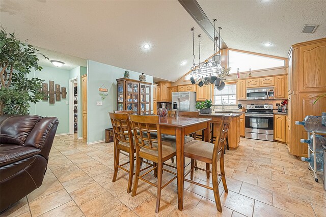 792 W Bayshore Dr, Palacios, TX 77465 - dining area featuring a textured ceiling, lofted ceiling, baseboards, and recessed lighting