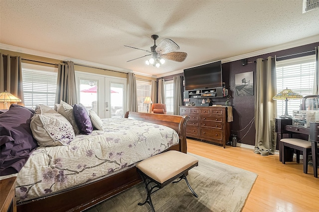 792 W Bayshore Dr, Palacios, TX 77465 - bedroom featuring a textured ceiling, crown molding, light wood-style floors, french doors, and access to outside