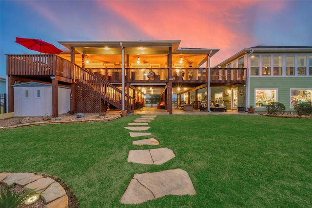 792 W Bayshore Dr, Palacios, TX 77465 - back of property featuring a deck, a lawn, stairs, and a patio