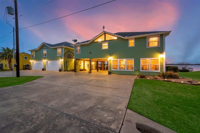 792 W Bayshore Dr, Palacios, TX 77465 - view of front of house featuring concrete driveway, a yard, and a garage