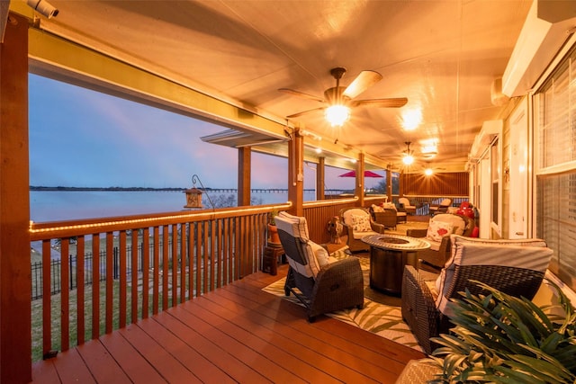 792 W Bayshore Dr, Palacios, TX 77465 - deck featuring a water view and an outdoor living space with a fire pit