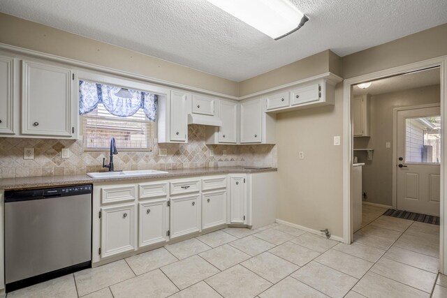 12114 Knobcrest Dr, Houston, TX 77070 - kitchen featuring stainless steel dishwasher, a sink, decorative backsplash, light tile patterned floors, and white cabinets