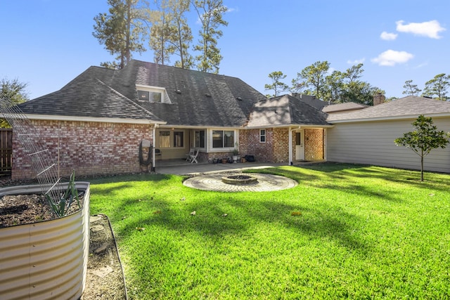 12114 Knobcrest Dr, Houston, TX 77070 - rear view of property featuring brick siding, an outdoor fire pit, and a yard