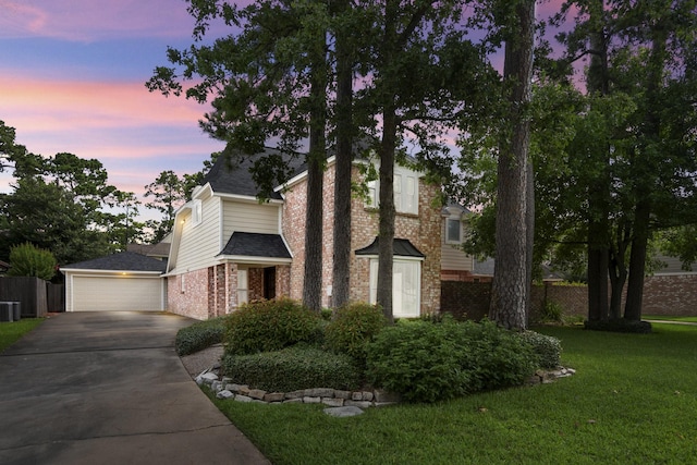 12114 Knobcrest Dr, Houston, TX 77070 - view of front of property featuring brick siding, driveway, central AC unit, a shingled roof, and a garage