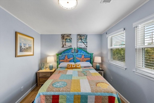 4220 Las Palmas St, Galveston, TX 77554 - bedroom with wood finished floors and crown molding