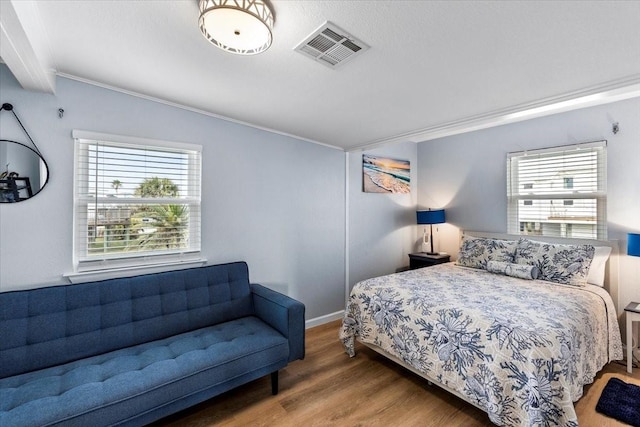 4220 Las Palmas St, Galveston, TX 77554 - bedroom with crown molding, wood finished floors, and multiple windows