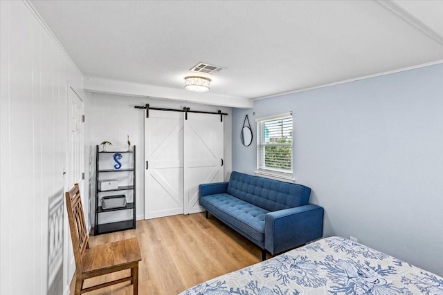 4220 Las Palmas St, Galveston, TX 77554 - bedroom featuring a barn door, wood finished floors, and crown molding