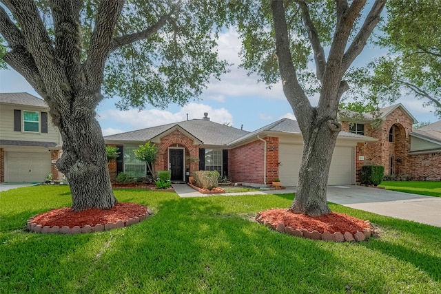 11826 Balmorhea Ln, Sugar Land, TX 77498 - view of front of home with brick siding, driveway, an attached garage, and a front yard