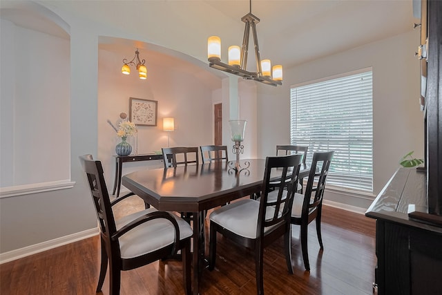 11826 Balmorhea Ln, Sugar Land, TX 77498 - dining room with a chandelier, baseboards, arched walkways, and dark wood-type flooring