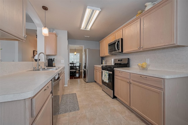 11826 Balmorhea Ln, Sugar Land, TX 77498 - kitchen featuring appliances with stainless steel finishes, a sink, light brown cabinets, light tile patterned flooring, and light countertops