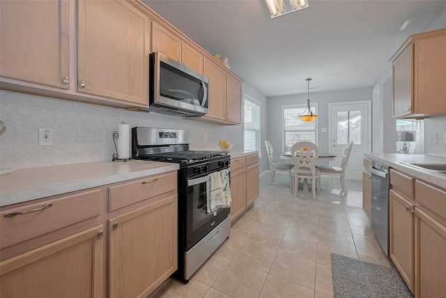 11826 Balmorhea Ln, Sugar Land, TX 77498 - kitchen featuring appliances with stainless steel finishes, light brown cabinets, light tile patterned floors, light countertops, and pendant lighting
