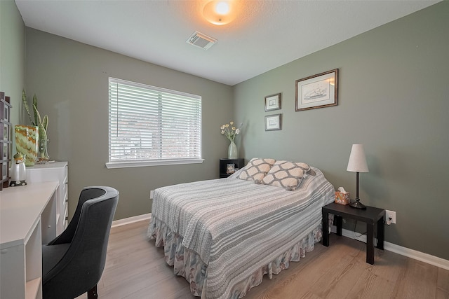 11826 Balmorhea Ln, Sugar Land, TX 77498 - bedroom with light wood finished floors and baseboards