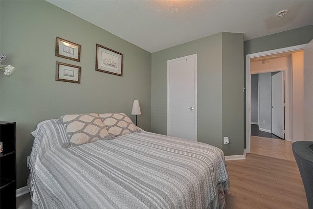 11826 Balmorhea Ln, Sugar Land, TX 77498 - bedroom with light wood finished floors and baseboards