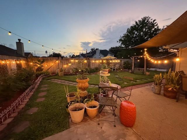 11826 Balmorhea Ln, Sugar Land, TX 77498 - yard at dusk with a patio area