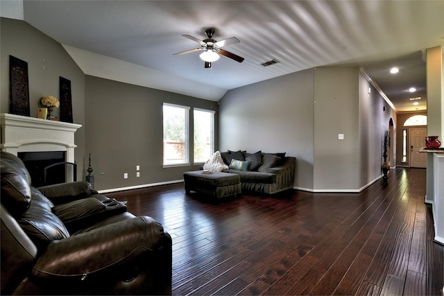 24302 Marisa Ln, Richmond, TX 77406 - living area featuring ceiling fan, dark wood-type flooring, a fireplace, arched walkways, and vaulted ceiling