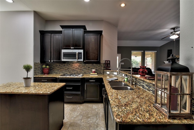 24302 Marisa Ln, Richmond, TX 77406 - kitchen with appliances with stainless steel finishes, tasteful backsplash, a peninsula, light stone countertops, and recessed lighting