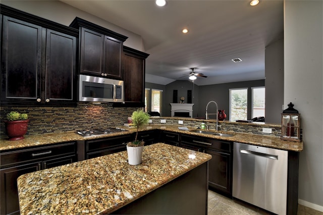 24302 Marisa Ln, Richmond, TX 77406 - kitchen with stainless steel appliances, ceiling fan, tasteful backsplash, light stone counters, and recessed lighting