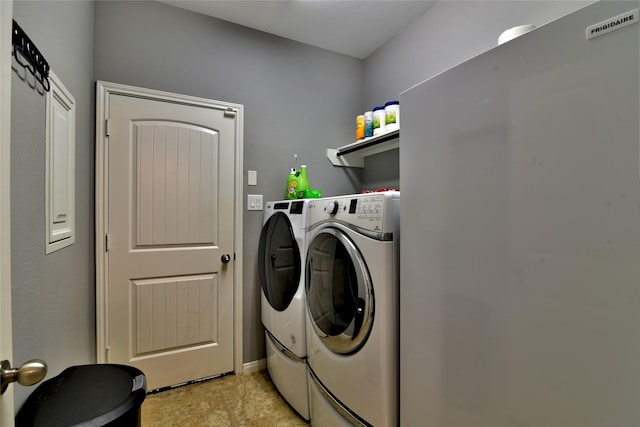 24302 Marisa Ln, Richmond, TX 77406 - laundry room with washing machine and dryer and baseboards