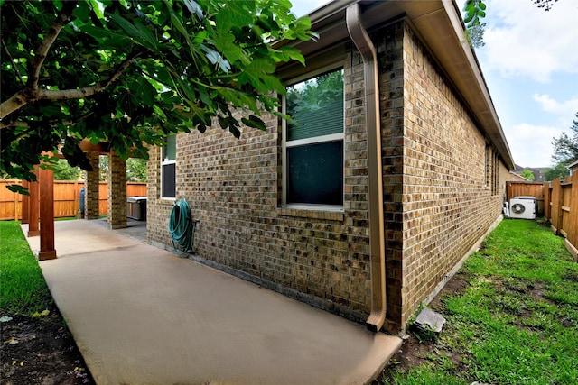 24302 Marisa Ln, Richmond, TX 77406 - view of side of home featuring brick siding, a patio, and a fenced backyard
