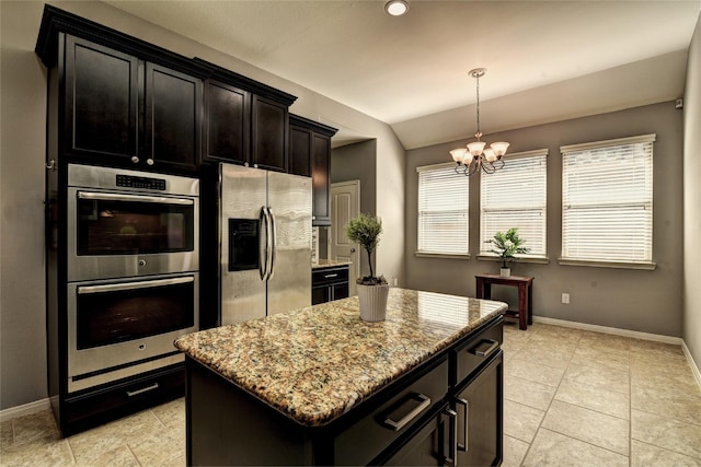 24302 Marisa Ln, Richmond, TX 77406 - kitchen featuring appliances with stainless steel finishes, lofted ceiling, a chandelier, light stone counters, and a center island