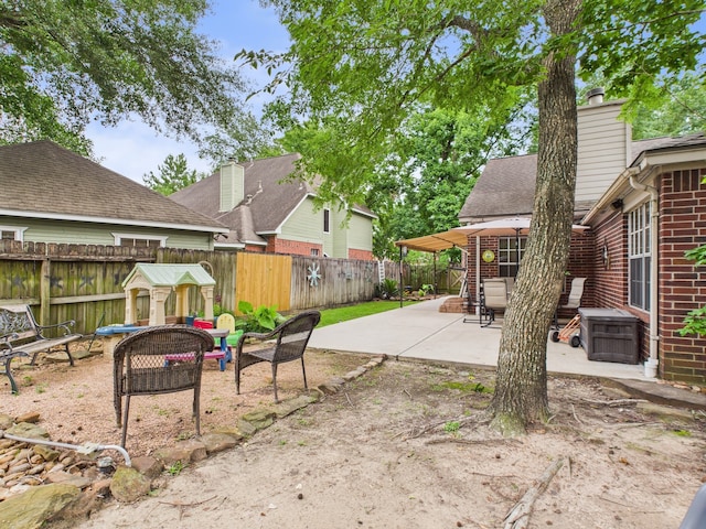 3707 Scenic Valley Dr, Kingwood, TX 77345 - fenced backyard featuring a fire pit and a patio area