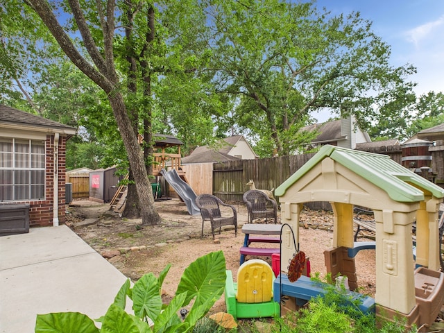 3707 Scenic Valley Dr, Kingwood, TX 77345 - fenced backyard featuring a playground and a patio