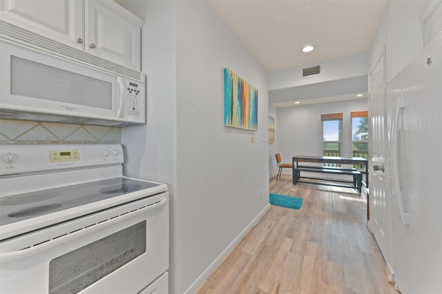 4003 Indian Beach Dr, Galveston, TX 77554 - kitchen featuring white appliances, light wood finished floors, white cabinets, baseboards, and recessed lighting