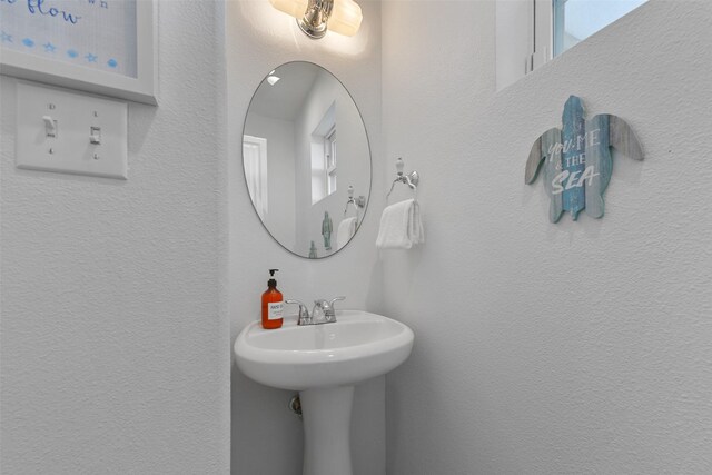 4003 Indian Beach Dr, Galveston, TX 77554 - bathroom with a textured wall and a sink