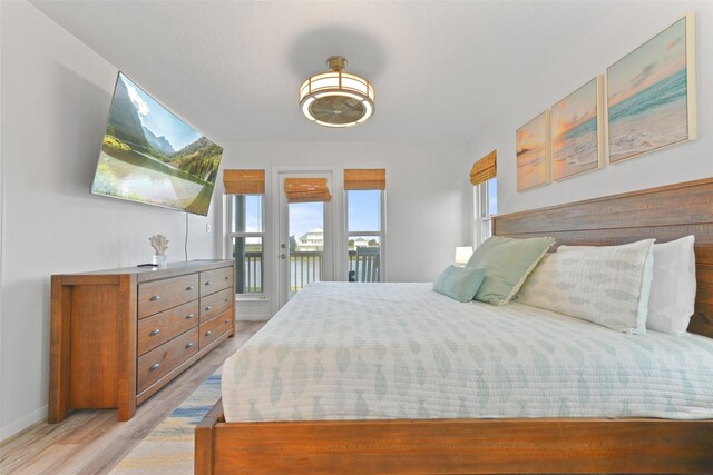 4003 Indian Beach Dr, Galveston, TX 77554 - bedroom featuring access to outside, light wood finished floors, and baseboards