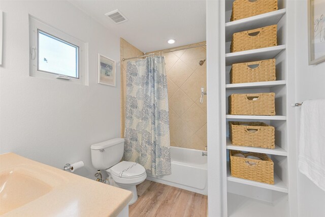 4003 Indian Beach Dr, Galveston, TX 77554 - bathroom with wood finished floors, vanity, shower / tub combo, toilet, and built in features
