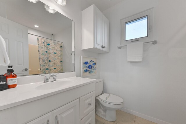 4003 Indian Beach Dr, Galveston, TX 77554 - full bath with toilet, tile patterned flooring, vanity, a shower with shower curtain, and baseboards