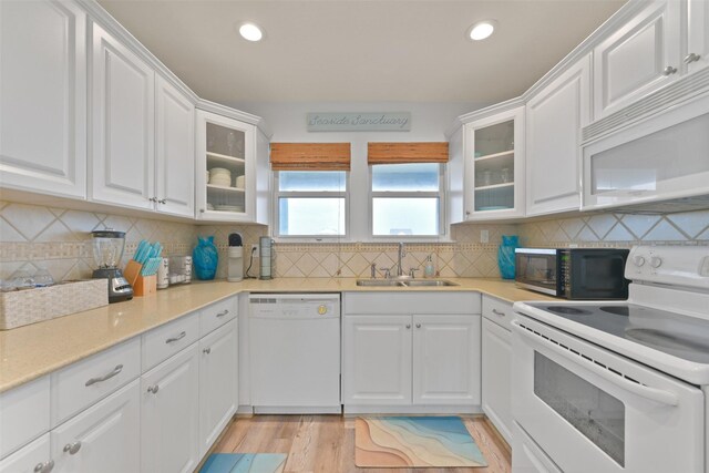 4003 Indian Beach Dr, Galveston, TX 77554 - kitchen featuring white appliances, a sink, white cabinetry, and recessed lighting