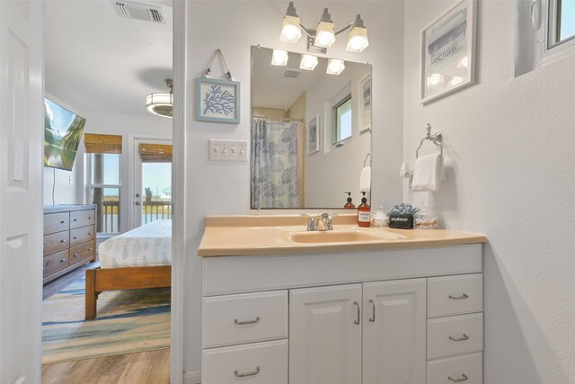 4003 Indian Beach Dr, Galveston, TX 77554 - full bath featuring vanity, wood finished floors, ensuite bathroom, and a shower with shower curtain