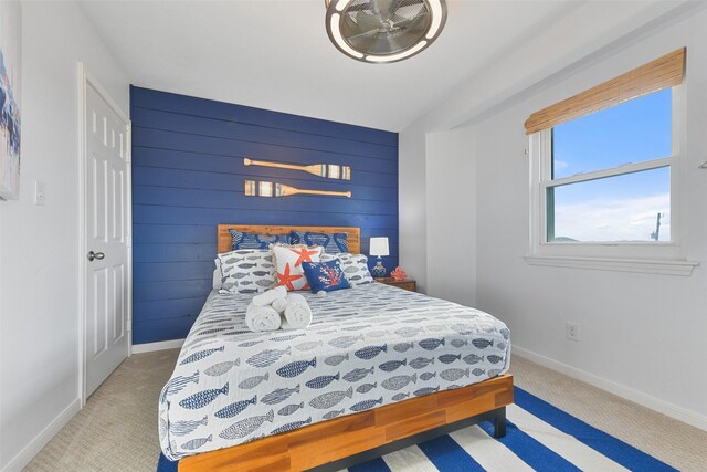 4003 Indian Beach Dr, Galveston, TX 77554 - bedroom featuring light carpet, baseboards, and wood walls