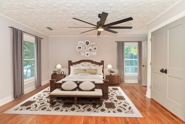 1031 Meyer St, Sealy, TX 77474 - bedroom featuring an ornate ceiling, wood finished floors, ceiling fan, and crown molding