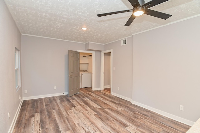 1031 Meyer St, Sealy, TX 77474 - unfurnished bedroom with washer / clothes dryer, wood finished floors, a textured ceiling, ceiling fan, and crown molding