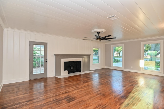1031 Meyer St, Sealy, TX 77474 - unfurnished living room with crown molding, healthy amount of natural light, wood finished floors, and a fireplace with flush hearth
