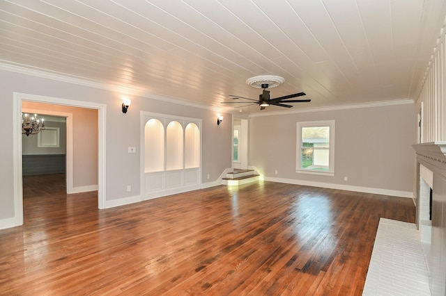 1031 Meyer St, Sealy, TX 77474 - unfurnished living room featuring a brick fireplace, crown molding, wood-type flooring, a chandelier, and a ceiling fan
