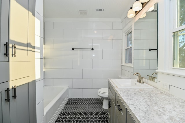 1031 Meyer St, Sealy, TX 77474 - bathroom featuring vanity, tile patterned floors, a bath, tile walls, and ornamental molding