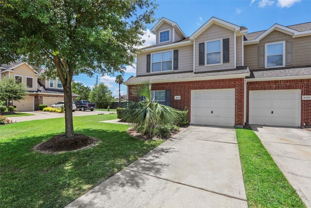 8315 Greys Ln, Houston, TX 77095 - view of property featuring brick siding, a front lawn, concrete driveway, a garage, and roof with shingles