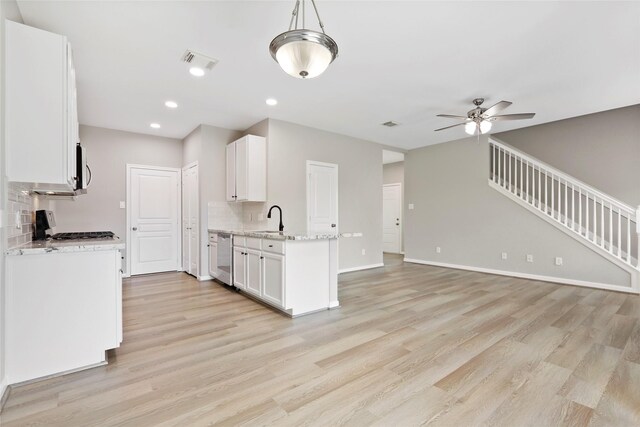 8315 Greys Ln, Houston, TX 77095 - kitchen featuring light wood-style flooring, white cabinets, ceiling fan, and recessed lighting