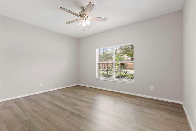 8315 Greys Ln, Houston, TX 77095 - spare room featuring wood finished floors, baseboards, and a ceiling fan