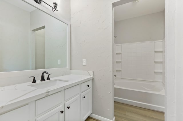 8315 Greys Ln, Houston, TX 77095 - bathroom with wood finished floors, vanity, and a textured wall