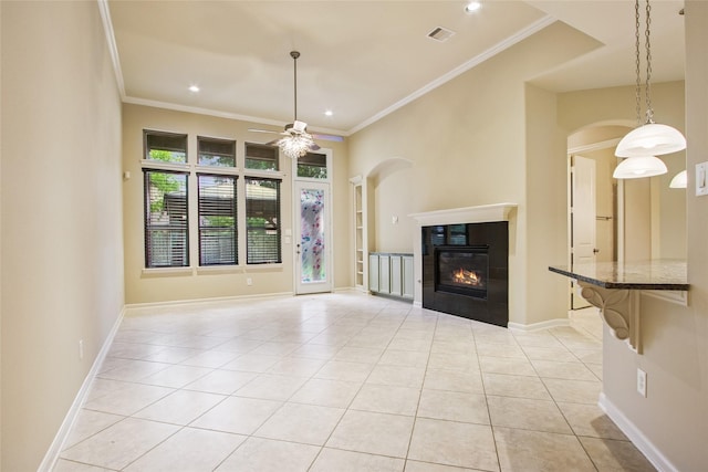 20702 Elderwood Terrace Dr, Richmond, TX 77406 - unfurnished living room featuring a ceiling fan, light tile patterned floors, arched walkways, crown molding, and recessed lighting