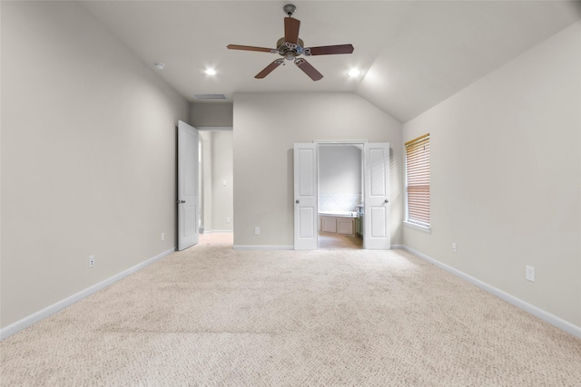 20702 Elderwood Terrace Dr, Richmond, TX 77406 - unfurnished bedroom with light carpet, baseboards, lofted ceiling, connected bathroom, and ceiling fan