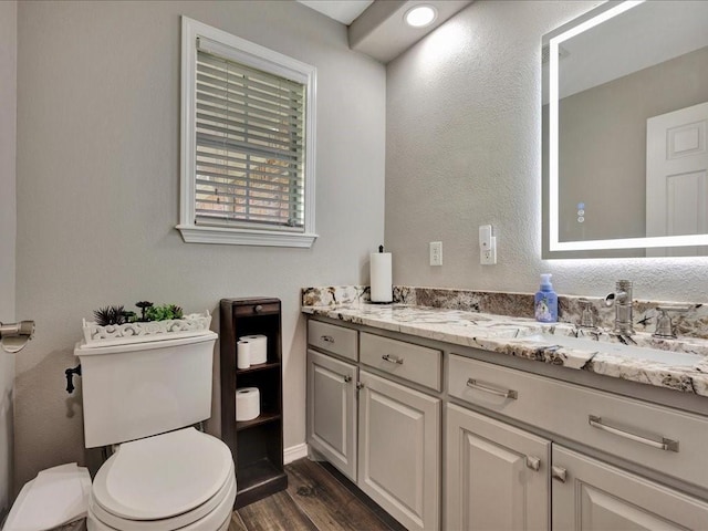 238 Royal Pnes, Lufkin, TX 75904 - bathroom featuring toilet, vanity, wood finished floors, and baseboards